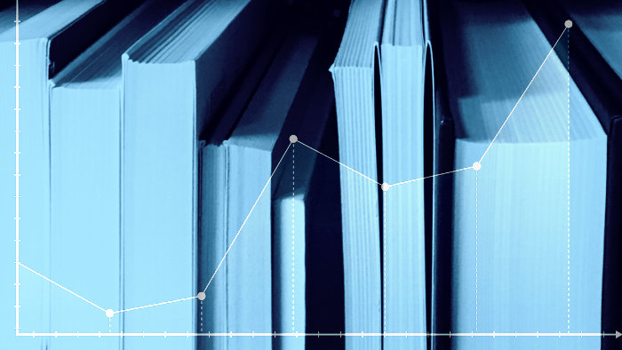 A blue-tinted monotone photo of a row of books with the covers facing away from the camera so only the edges of the pages show. Overlaid on top of the photo is a graph plot with a line gradually increasing.